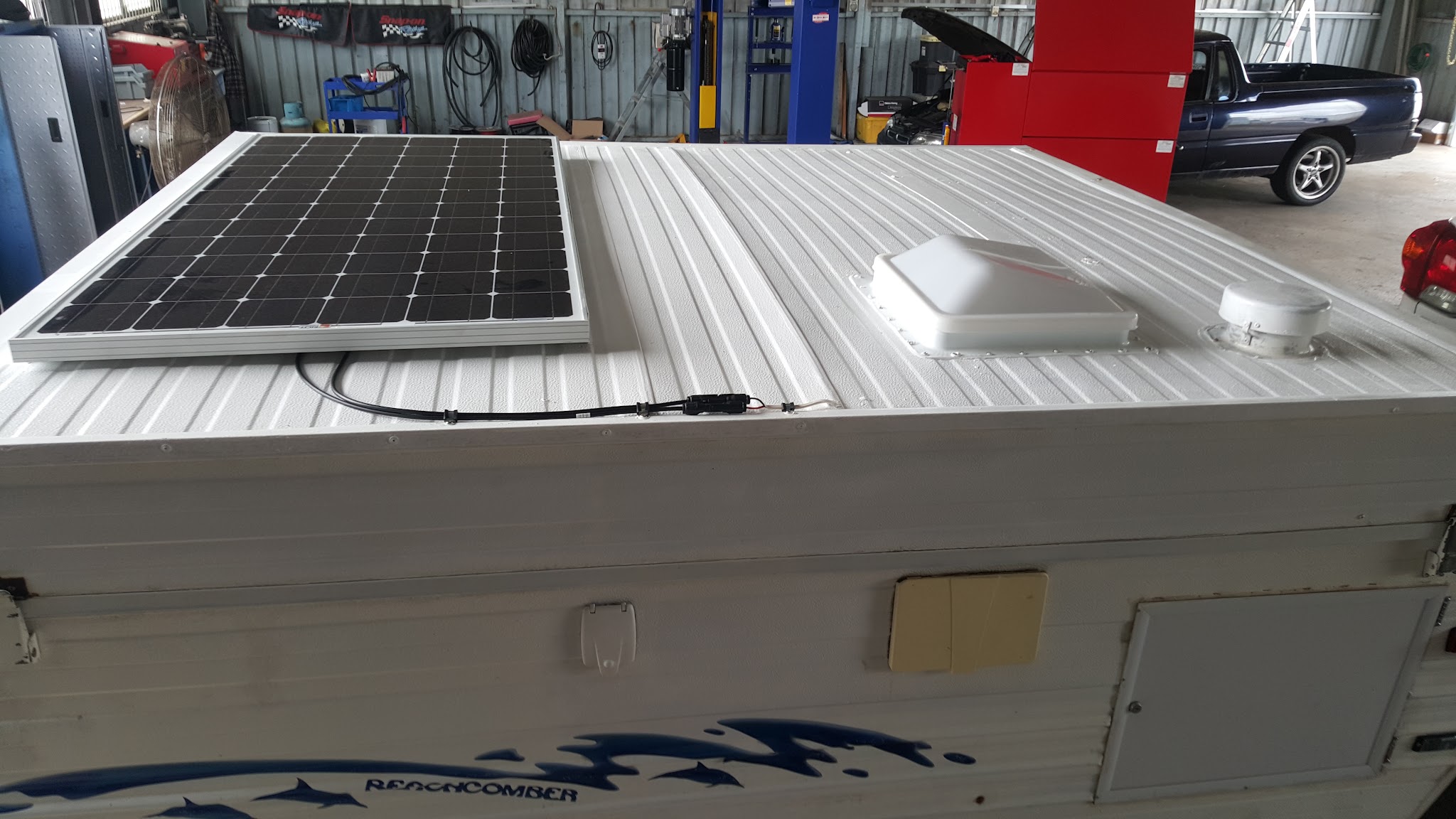 A solar panel mounted and wired in on the roof of a caravan